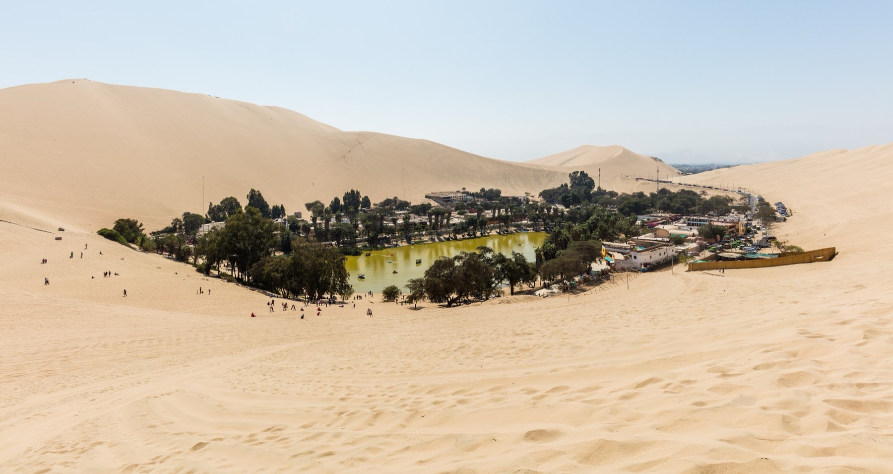 The Huacachina oasis surrounded by the dunes of the Ica Desert